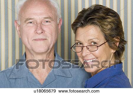 Stock Photo - Portrait of happy couple dressed in blue. Fotosearch
