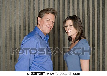 Stock Photo - Portrait of happy couple dressed in blue. Fotosearch