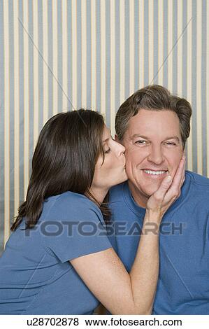 Stock Photo - Portrait of happy couple dressed in blue. Fotosearch