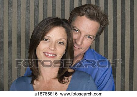 Stock Photograph - Portrait of happy couple dressed in blue. Fotosearch
