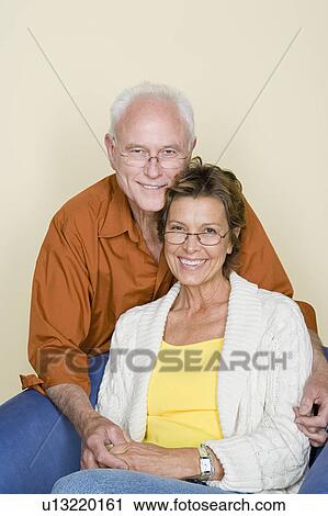 Stock Image - Portrait of happy couple holding hands. Fotosearch