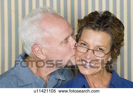 Stock Photography - Portrait of happy couple kissing. Fotosearch