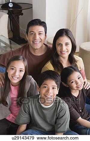 Stock Photo - Portrait of happy family with three children (8-9, 10-11). Fotosearch