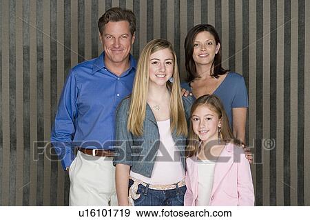 Stock Photo - Portrait of happy family with two girls (8-9, 14-15). Fotosearch
