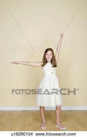 Picture - Portrait of happy girl (8-9) dressed in white. Fotosearch