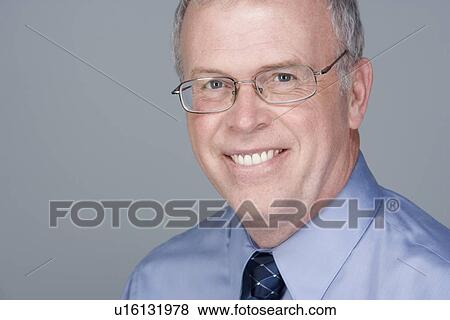 Stock Photo - Portrait of happy mature businessman. Fotosearch