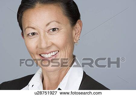 Stock Photo - Portrait of happy mature businesswoman. Fotosearch