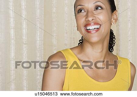 Stock Image - Portrait of happy mid adult african woman. Fotosearch