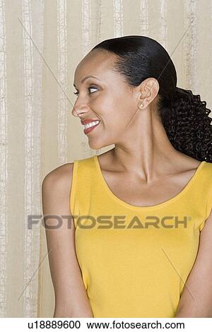 Stock Image - Portrait of happy mid adult african woman. Fotosearch