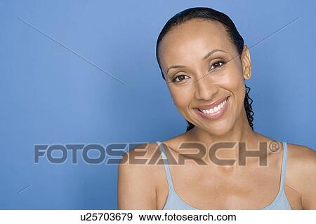 Portrait of happy mid adult african woman sitting on chair View Large Photo Image Stock Photo - Portrait of happy mid adult african woman sitting on chair. Fotosearch
