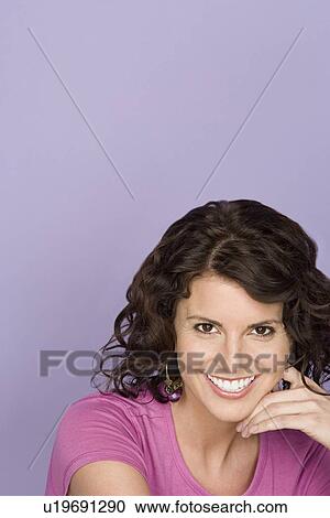 Portrait of happy mid adult woman wearing pink top View Large Photo Image Stock Image - Portrait of happy mid adult woman wearing pink top. Fotosearch