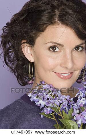 Portrait of happy mid adult woman holding bunch of flowers View Large Photo Image Stock Photo - Portrait of happy mid adult woman holding bunch of flowers. Fotosearch