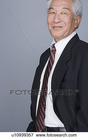 Stock Photo - Portrait of happy senior businessman. Fotosearch