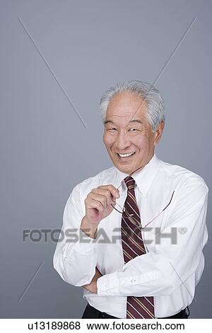 Stock Photo - Portrait of happy senior businessman. Fotosearch