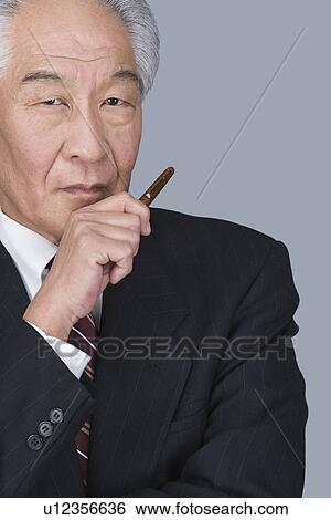 Stock Photograph - Portrait of happy senior businessman. Fotosearch