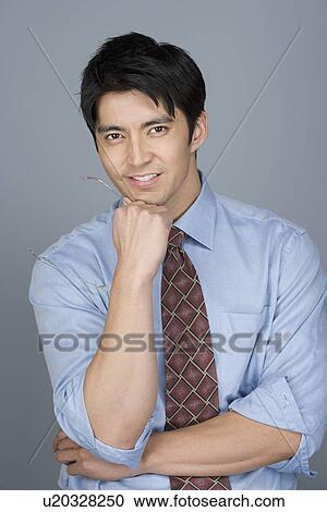 Stock Image - Portrait of happy young businessman. Fotosearch