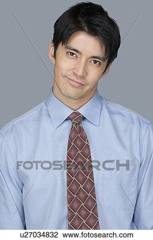 Stock Image - Portrait of happy young businessman. Fotosearch