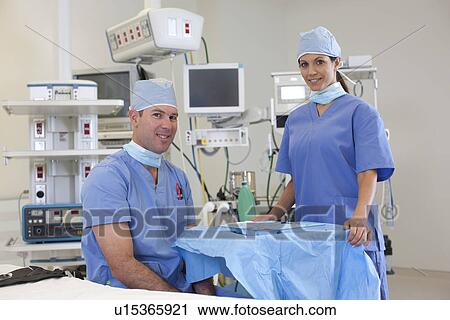 Portrait of male and female surgeons in operating room View Large Photo Image Stock Image - Portrait of male and female surgeons in operating room. Fotosearch