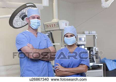 Portrait of male and female surgeons in operating room View Large Photo Image Stock Image - Portrait of male and female surgeons in operating room. Fotosearch