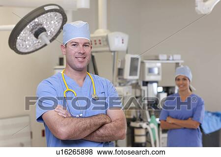 Portrait of male and female surgeons in operating room View Large Photo Image Stock Photo - Portrait of male and female surgeons in operating room. Fotosearch