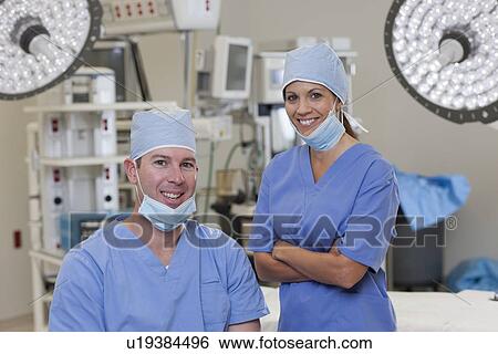 Portrait of male and female surgeons in operating room View Large Photo Image Stock Photograph - Portrait of male and female surgeons in operating room. Fotosearch