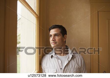 Portrait of man looking out window View Large Photo Image Stock Photo - Portrait of man looking out window. Fotosearch