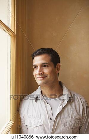 Portrait of man looking out window View Large Photo Image Stock Photograph - Portrait of man looking out window. Fotosearch