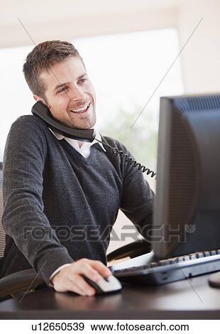 Portrait of man working in office View Large Photo Image Stock Photo - Portrait of man working in office. Fotosearch