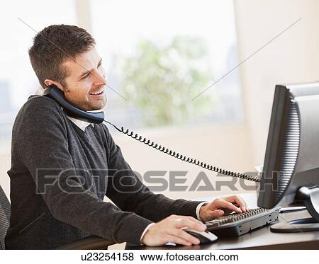 Portrait of man working in office View Large Photo Image Stock Photo - Portrait of man working in office. Fotosearch