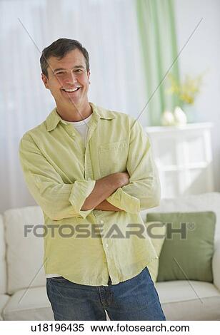 Stock Photography - Portrait of mature man at home. Fotosearch