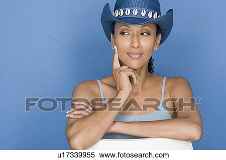 Portrait of mid adult woman sitting on white chair, wearing blue cowboy hat View Large Photo Image Stock Photography - Portrait of mid adult woman sitting on white chair, wearing blue cowboy hat. Fotosearch