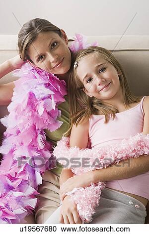 Portrait of mother and daughter (10-11) wearing feather boa at slumber party View Large Photo Image Stock Image - Portrait of mother and daughter (10-11) wearing feather boa at slumber party. Fotosearch