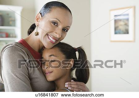 Portrait of Mother hugging Daughter (10-11) View Large Photo Image Stock Photo - Portrait of Mother hugging Daughter (10-11). Fotosearch