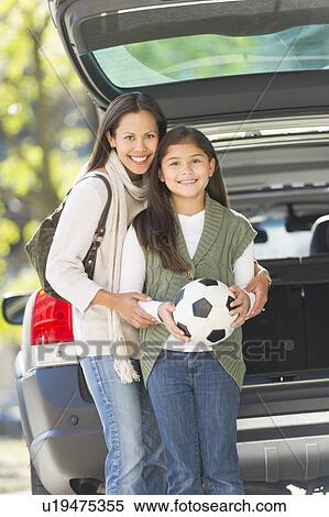 Portrait of mother with daughter (10-11) holding soccer ball View Large Photo Image Stock Photography - Portrait of mother with daughter (10-11) holding soccer ball. Fotosearch