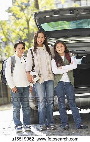 Stock Image - Portrait of mother with son (12-13) and daughter (10-11) . Fotosearch