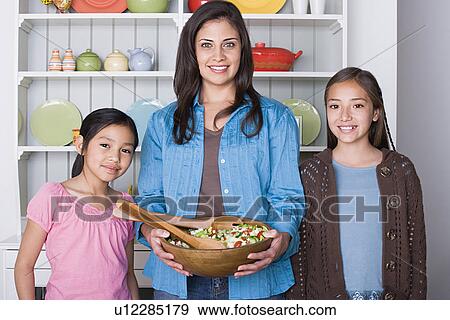 Portrait of mother with two daughters (8-9, 10-11) in kitchen View Large Photo Image Stock Photo - Portrait of mother with two daughters (8-9, 10-11) in kitchen. Fotosearch