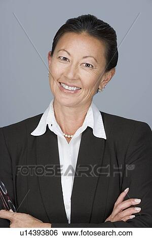Stock Photograph - Portrait of portrait of happy mature businesswoman. Fotosearch