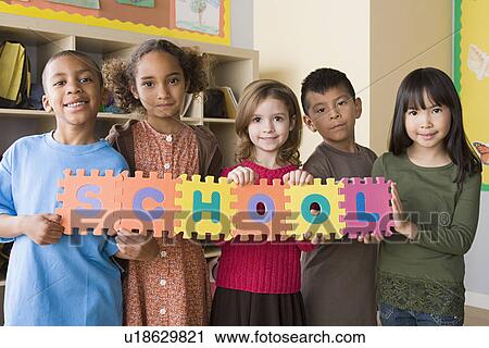 Portrait of schoolchildren (6-7) holding colorful letters View Large Photo Image Stock Image - Portrait of schoolchildren (6-7) holding colorful letters. Fotosearch