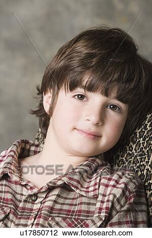Portrait of smiling (6-7) boy, studio shot View Large Photo Image Stock Image - Portrait of smiling (6-7) boy, studio shot. Fotosearch