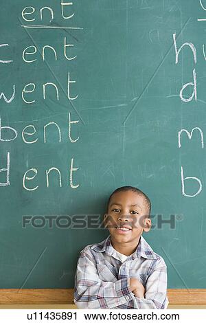 Portrait of smiling boy (6-7) against blackboard View Large Photo Image Stock Image - Portrait of smiling boy (6-7) against blackboard. Fotosearch