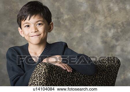 Picture - Portrait of smiling boy (8-9), studio shot. Fotosearch