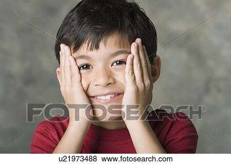Portrait of smiling boy (8-9) with hands on face, studio shot View Large Photo Image Stock Photo - Portrait of smiling boy (8-9) with hands on face, studio shot. Fotosearch