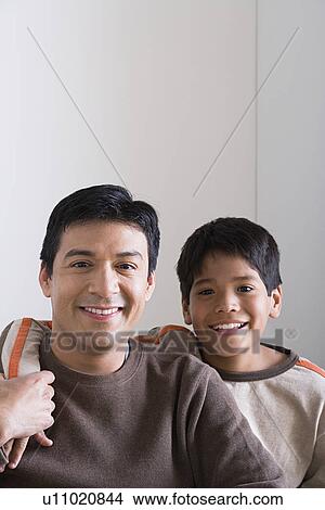 Portrait of smiling father and son (10-11) View Large Photo Image Picture - Portrait of smiling father and son (10-11). Fotosearch