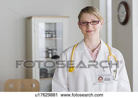 Stock Image - Portrait of smiling female doctor. Fotosearch