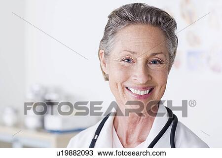 Stock Image - Portrait of smiling female doctor. Fotosearch