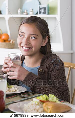 Portrait of smiling girl (10-11) at table View Large Photo Image Stock Image - Portrait of smiling girl (10-11) at table. Fotosearch