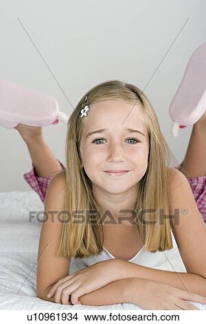 Portrait of smiling girl (10-11) in pajamas View Large Photo Image Picture - Portrait of smiling girl (10-11) in pajamas. Fotosearch