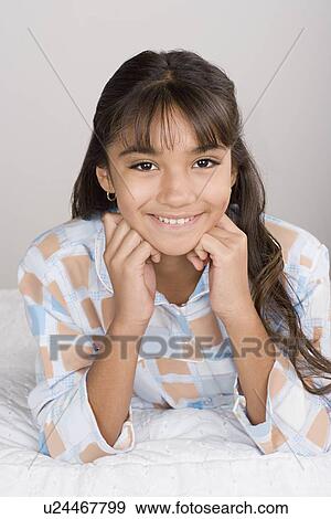 Portrait of smiling girl (10-11) in pajamas View Large Photo Image Stock Photo - Portrait of smiling girl (10-11) in pajamas. Fotosearch
