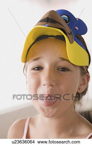 Portrait of smiling girl (10-11) sticking out tongue View Large Photo Image Picture - Portrait of smiling girl (10-11) sticking out tongue. Fotosearch