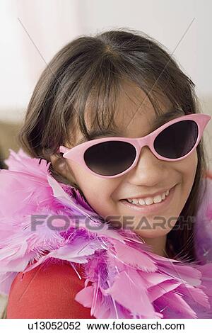 Portrait of smiling girl (10-11) wearing feather boa and sunglasses View Large Photo Image Stock Image - Portrait of smiling girl (10-11) wearing feather boa and sunglasses. Fotosearch